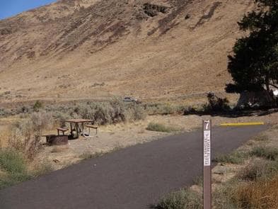 Big Pines Campsite 7 with picnic table, fire ring and parking space.