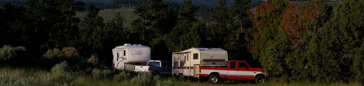 Trucks and trailers in a group campsite.