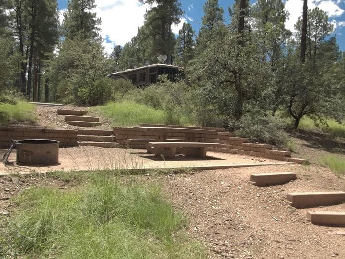 Site 35 Three Stairs To The Cement Platform With A Cement Table And Metal Fire Ring, Six Stairs To Parking and Toilet, No Handrail
