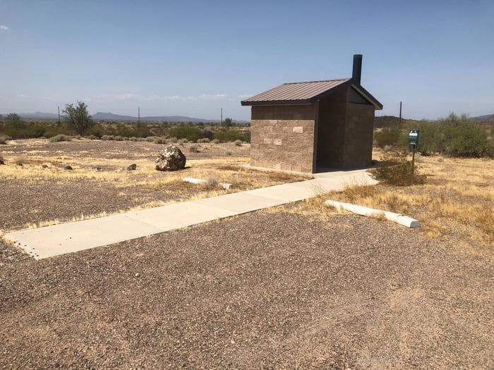 West single vault toilet with parking and cement walkway