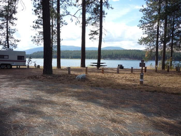 Gifford Campground with trees and lake in the background.