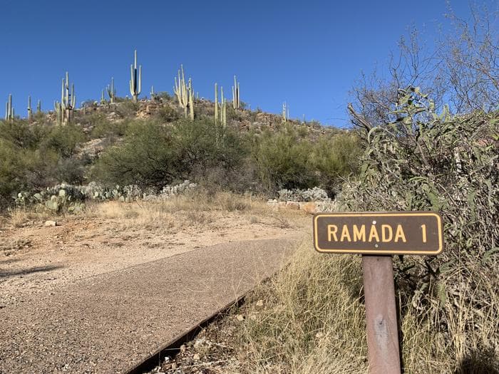 Paved path to the left of a sign saying "Ramada 1"
