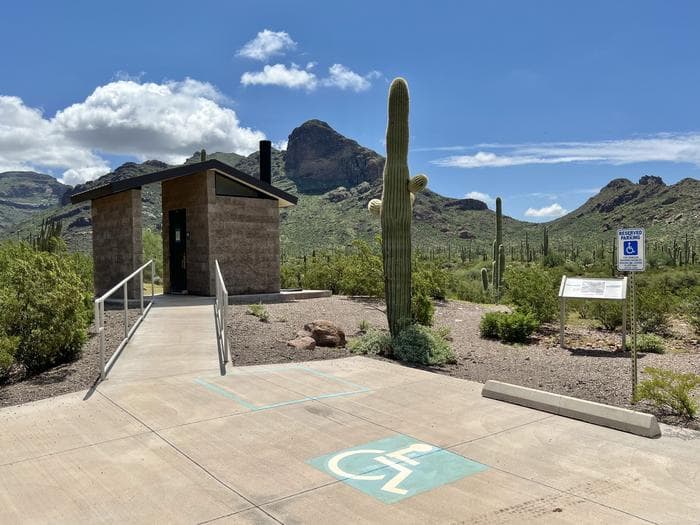 The vault toilet restroom near the ADA accessible parking.