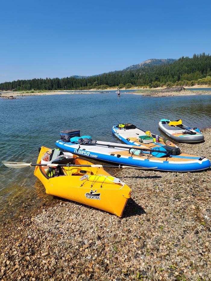 Paddle boards and a kayak along the shores of the Pend Oreille River at Pioneer Park Campground