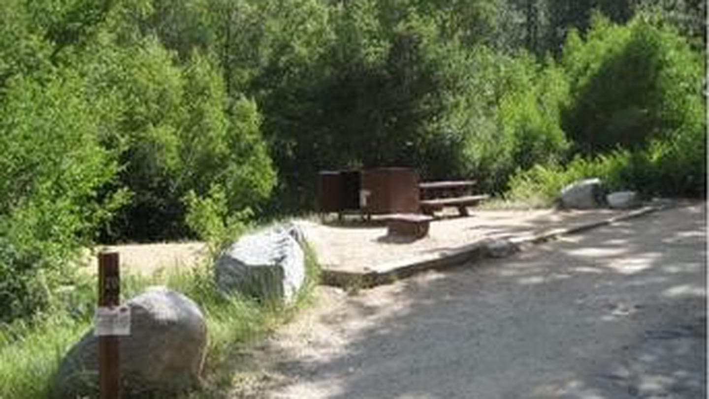 Large boulders frame a campsite in the forest