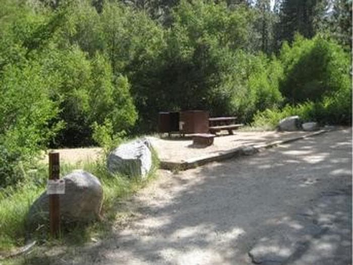 Large boulders frame a campsite in the forest