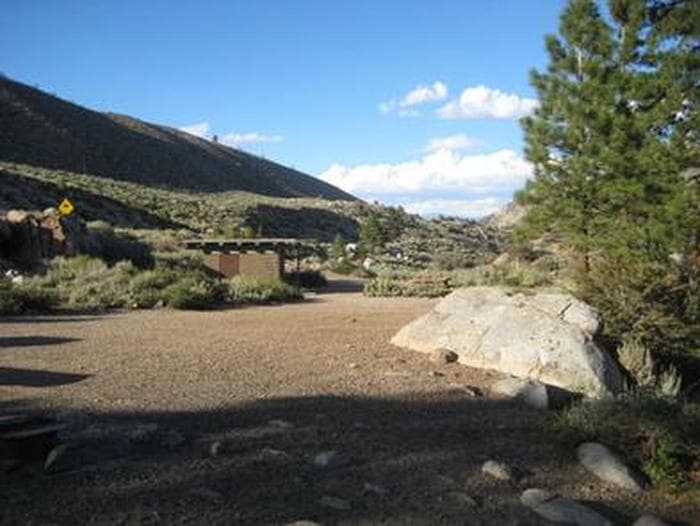A large gravel group campsite in the mountains