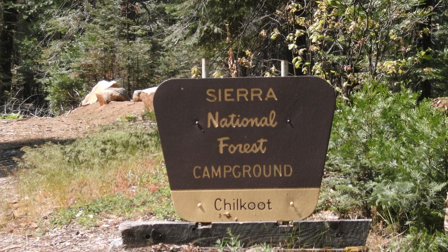 A brown and yellow Forest Sign for Chilkoot Campground on the Sierra National Forest