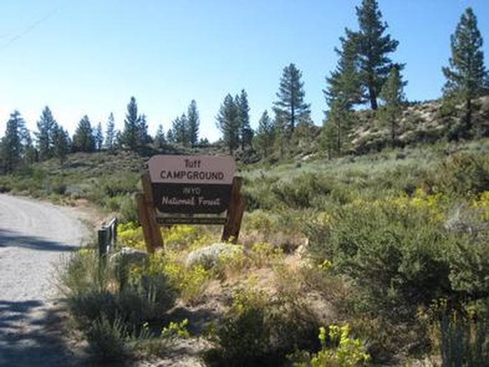 A brown and yellow Forest Service sign for Tuff Campground