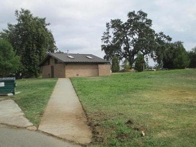 Bathhouse with flush toilets, quarter operated showers